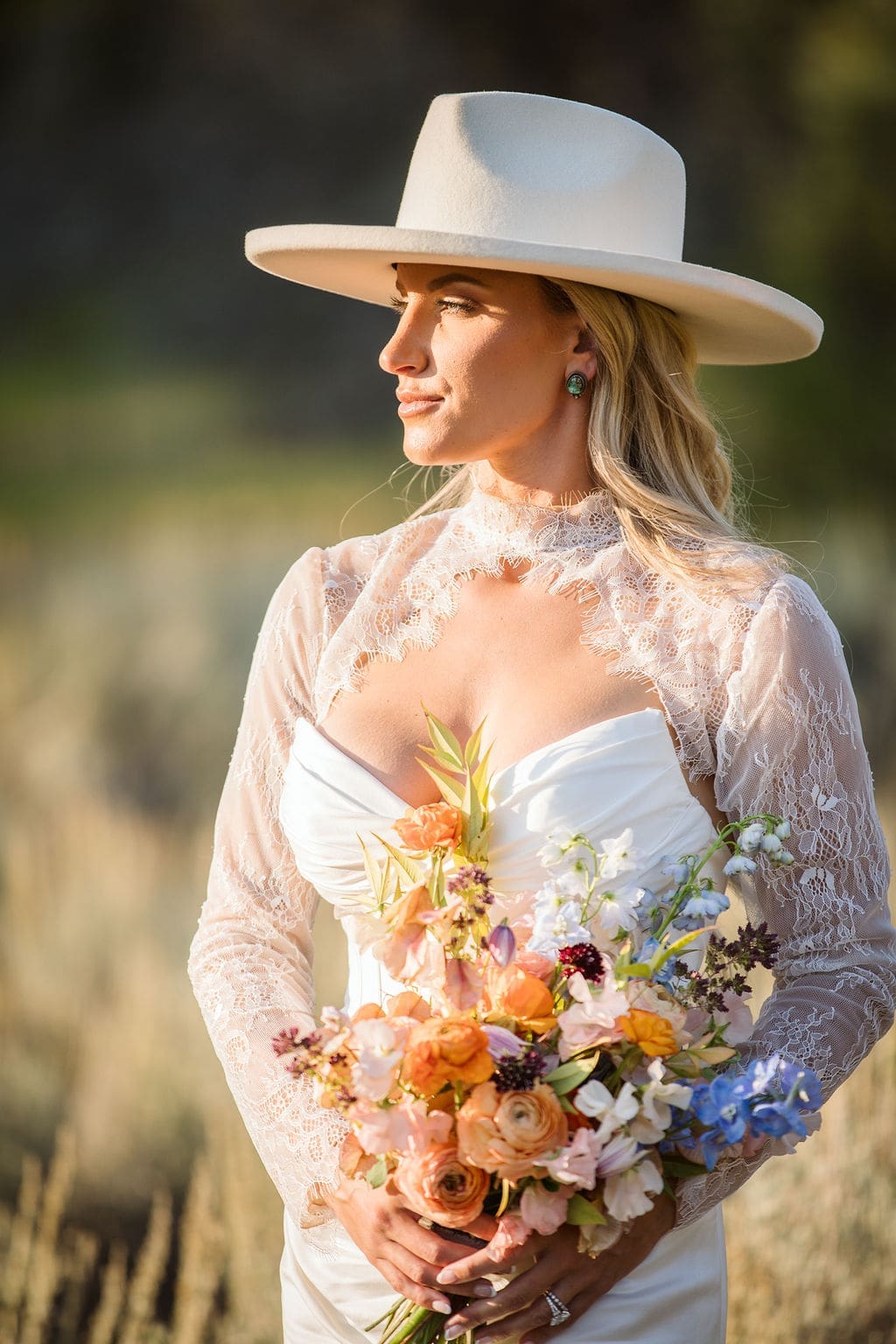 Bride holding bouquet at sunset during Bozeman wedding. 