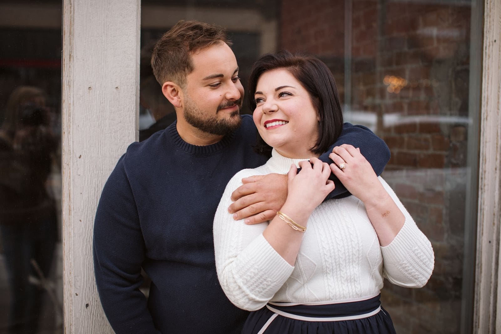 Couple standing in front of building during engagement photos with Montana wedding photographer