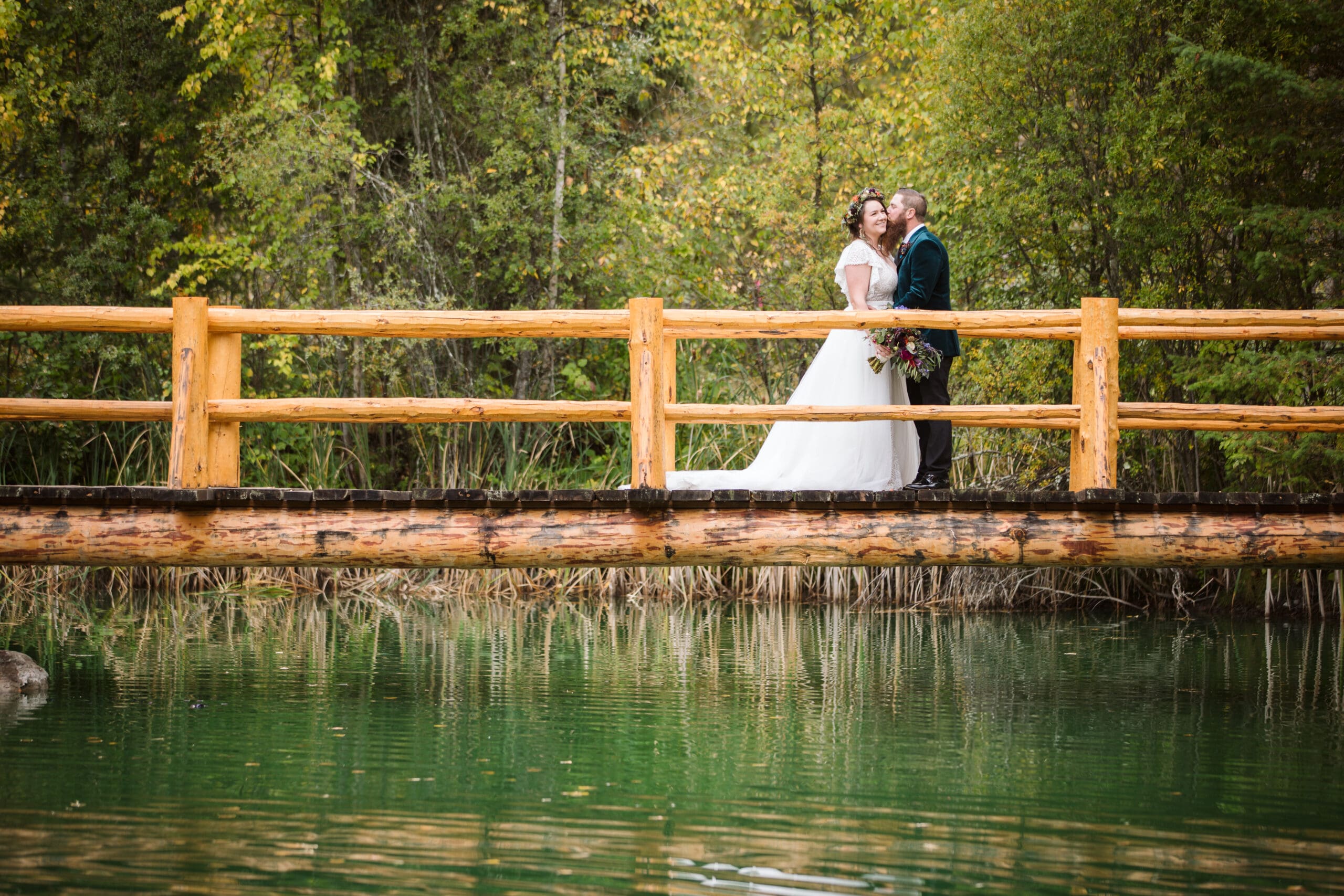 Couple standing on bridge over water at Paddle Ridge. 