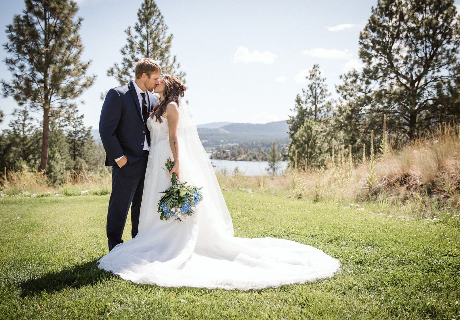 Bride and groom kissing at mid day during their portrait time on Montana wedding day.