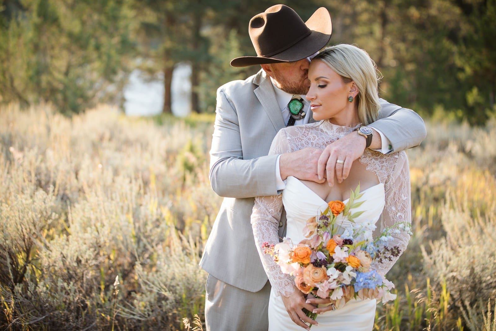 Bride and groom snuggling together at sunset during their golden hour portraits on their Montana wedding day.