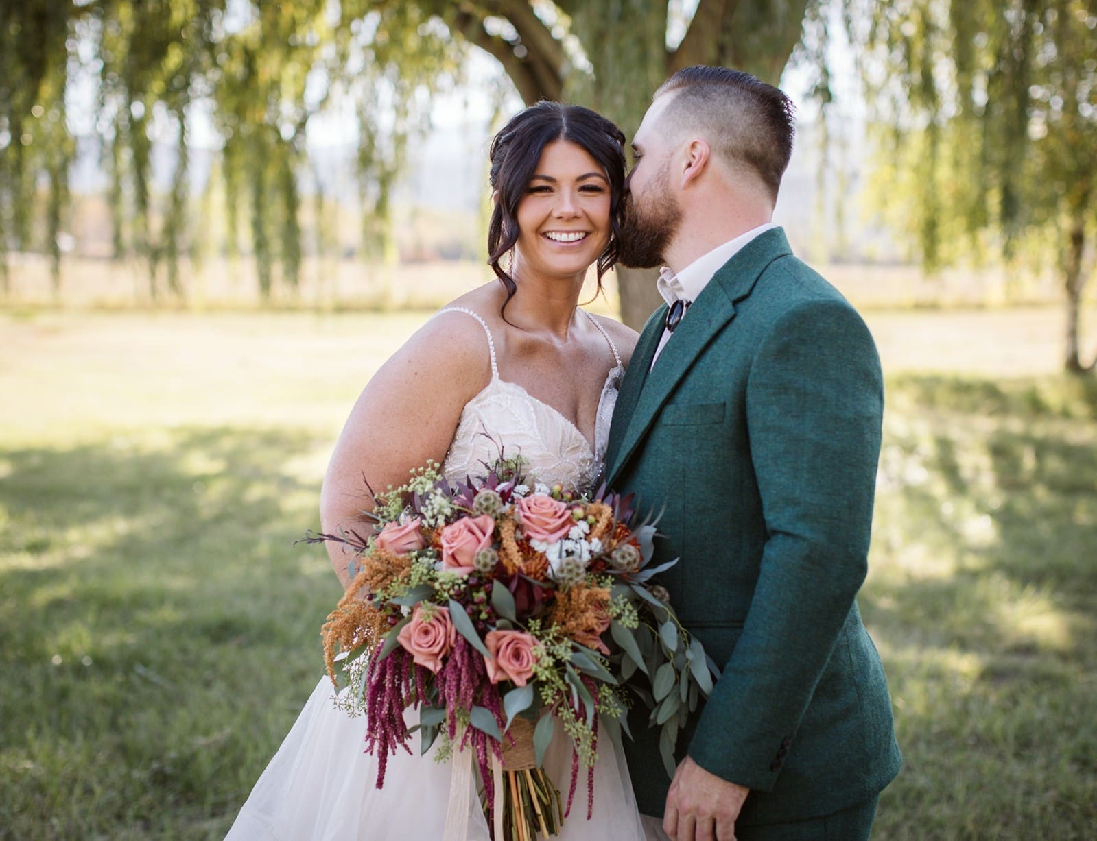 Groom kissing his bride's cheek after their first look on a Montana wedding day.